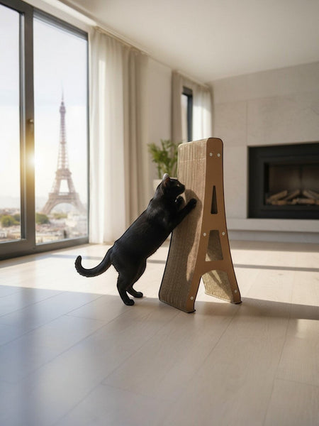 Gatitud Store Eiffel Tower cat scratcher made of durable cardboard, used by a black cat in a modern apartment with Paris view.