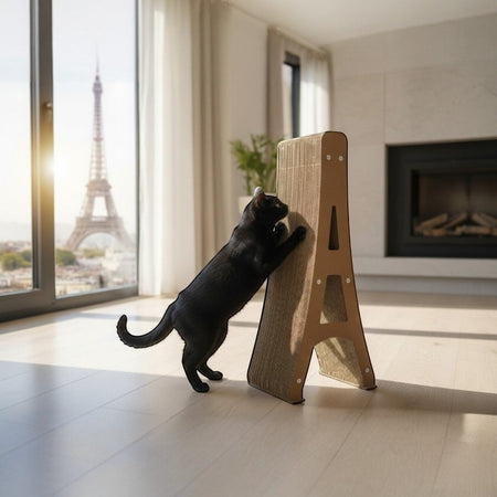 Gatitud Store Eiffel Tower cat scratcher made of durable cardboard, used by a black cat in a modern apartment with Paris view.